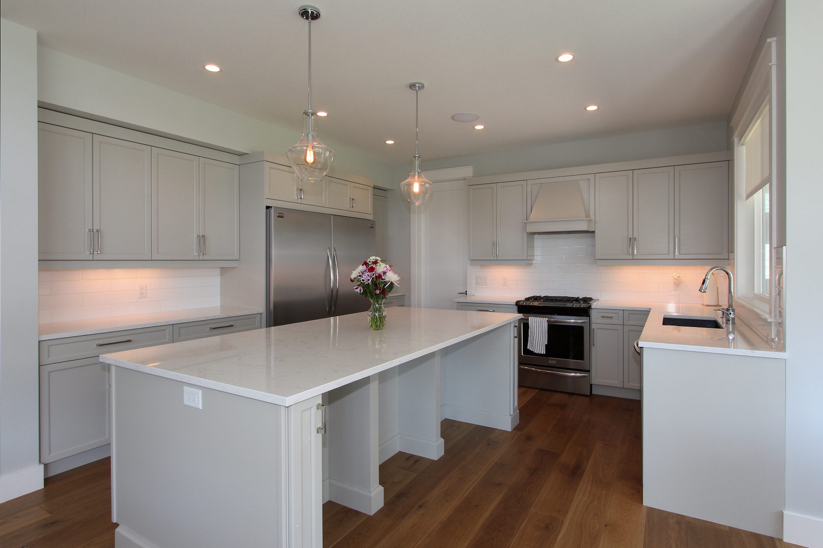 Custom kitchen at 447 Lakepoint Drive with light grey cabinets and a large island