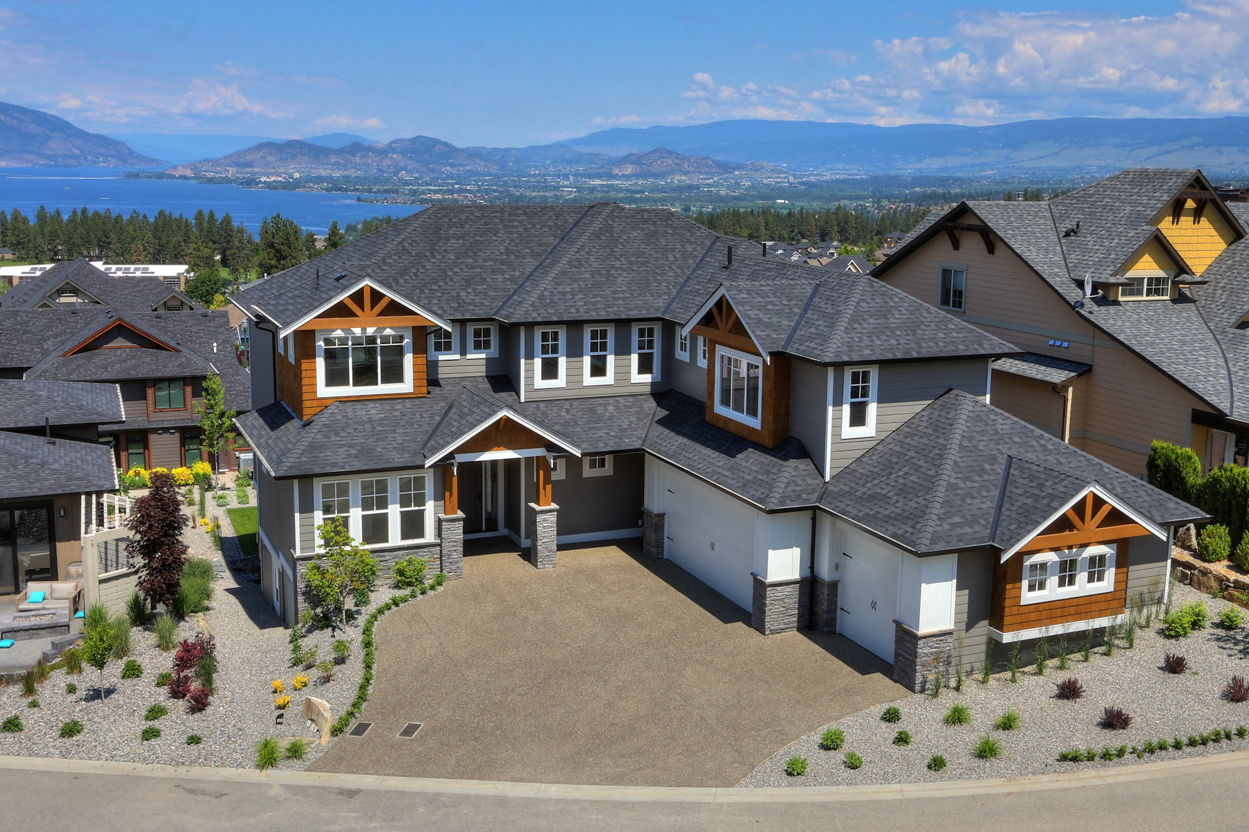 Aerial view of a custom home build by Stark Homes in Kelowna, with Okanagan Lake in the background
